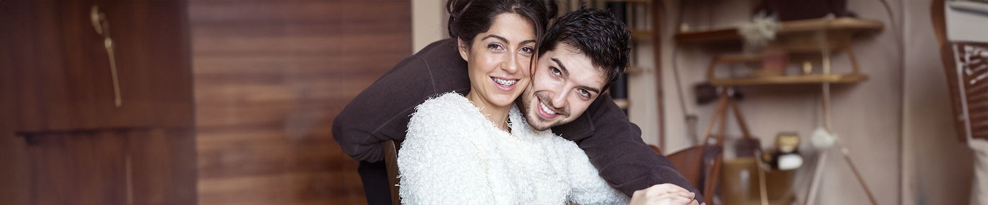 Happy couple smiling, with woman having dental braces