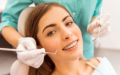 Teen in dental chair for dental braces check-up