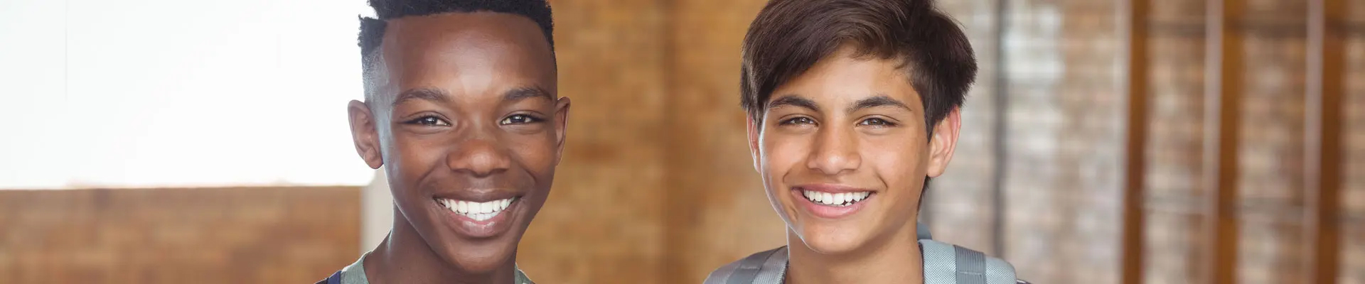 A couple of kids smiling with perfect teeth